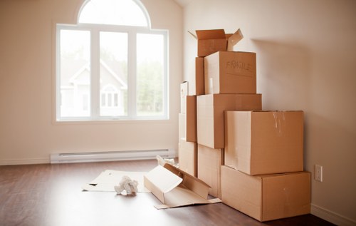 Packed moving boxes and furniture ready for transport in Deptford
