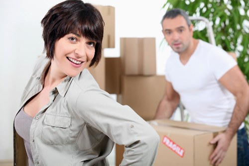 Mover wearing PPE while carrying furniture safely